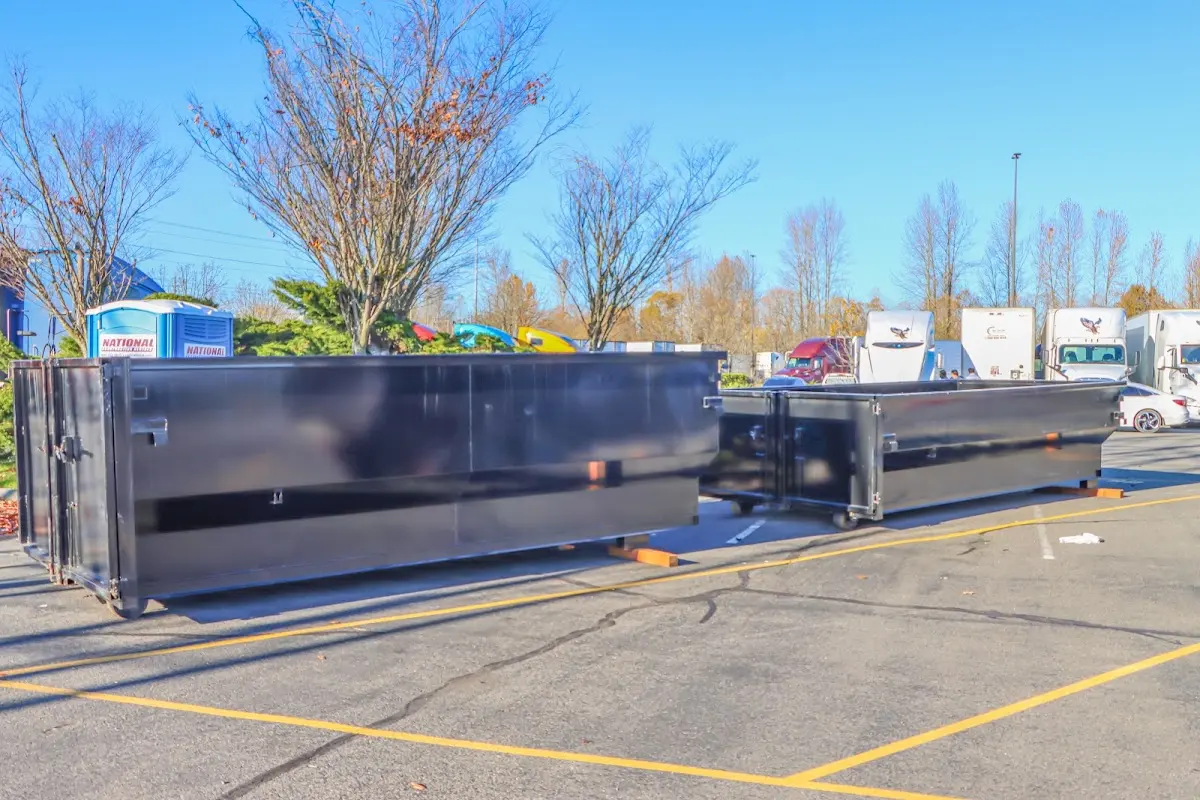 Professional dumpster rental service with roll-off container on residential driveway in Poway